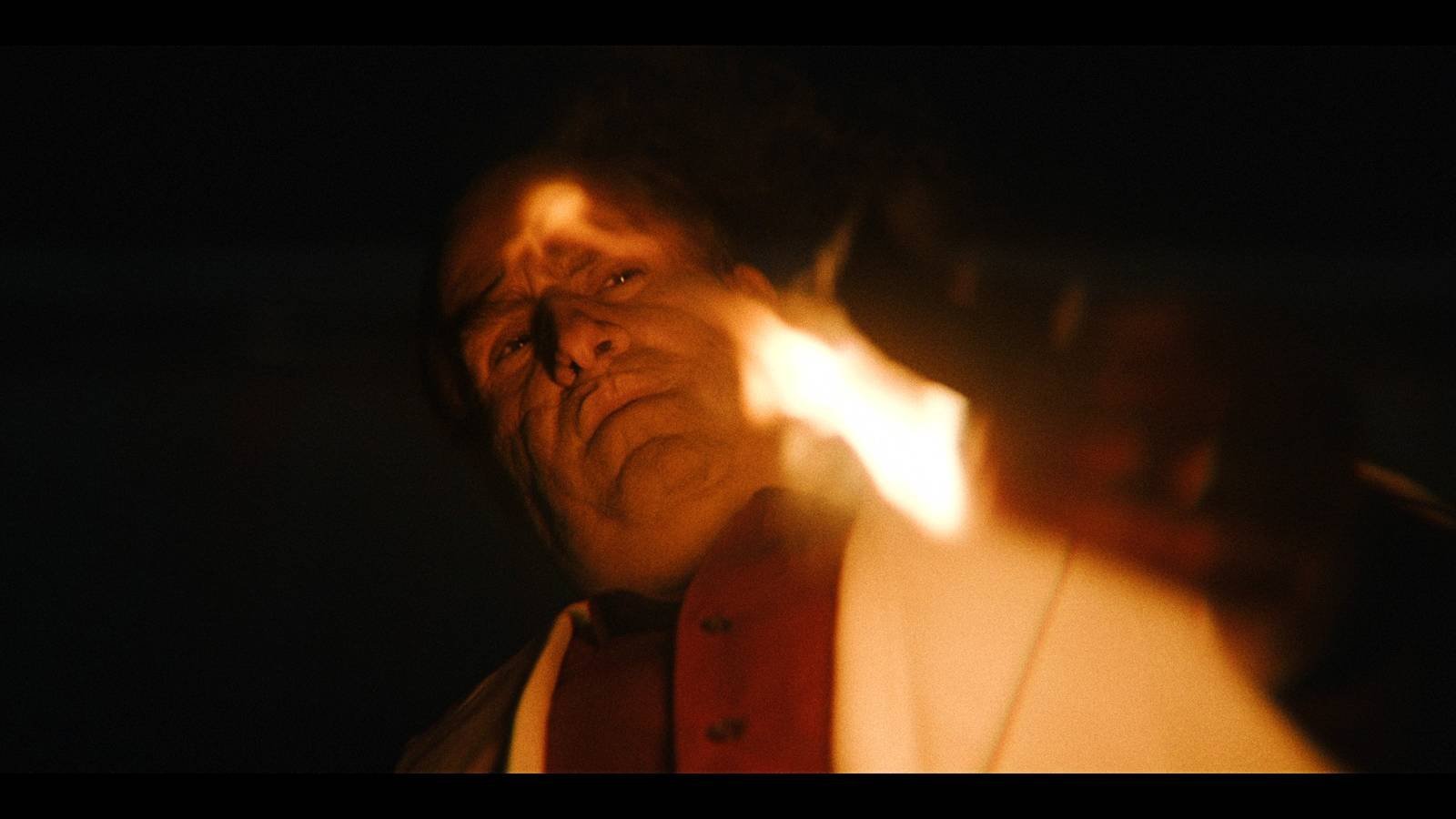 Colin Farrell As Oz Cobb Holding A Burning Match And Looking Down In The Penguin Trailer