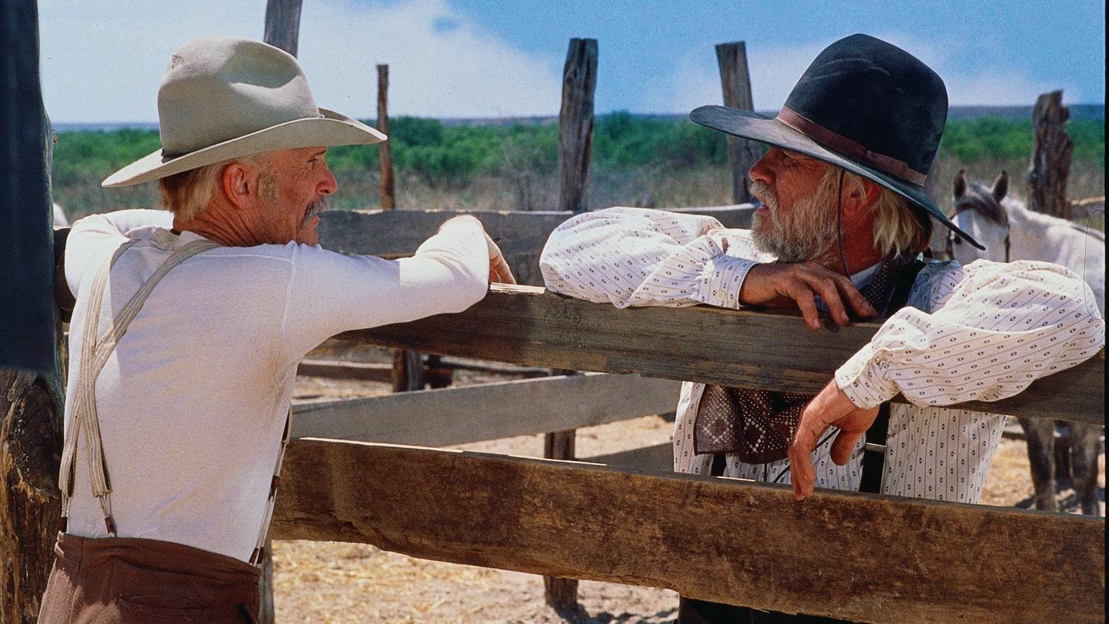 Robert Duvall and Tommy Lee Jones as Gus McCrae and Woodrow Call leaning on a fence in Lonesome Dove