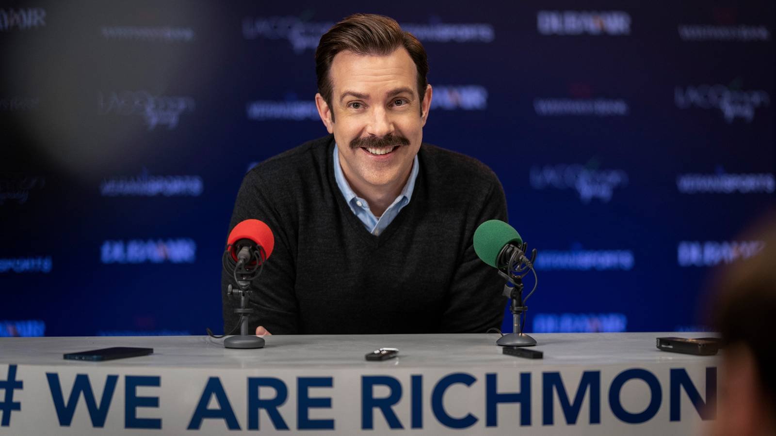 Jason Sudeikis smiling in Apple TV's Ted Lasso