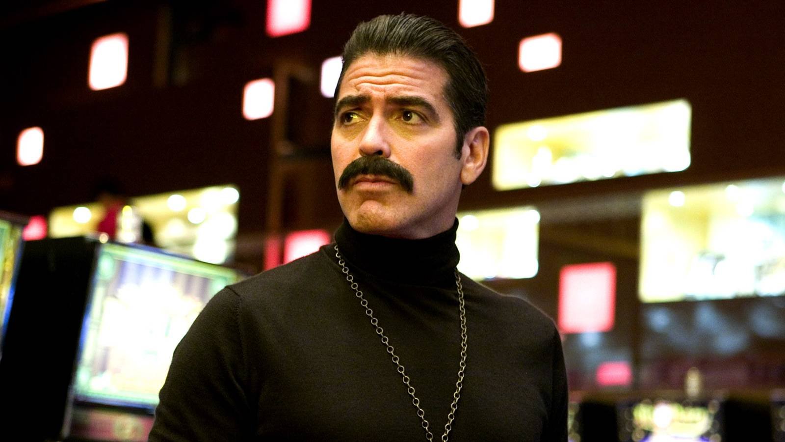 George Clooney as Danny Ocean wearing a fake mustache in Ocean's 13