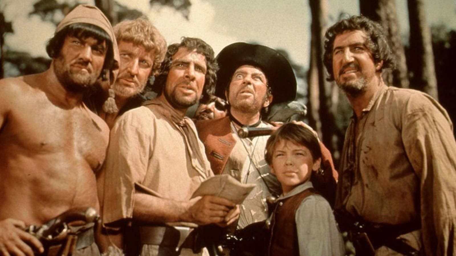 Jim and the Pirates look on in Treasure Island