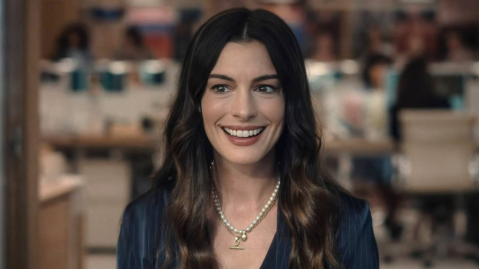 Anne Hathaway as Andy Sachs smiling in The Devil Wears Prada 2