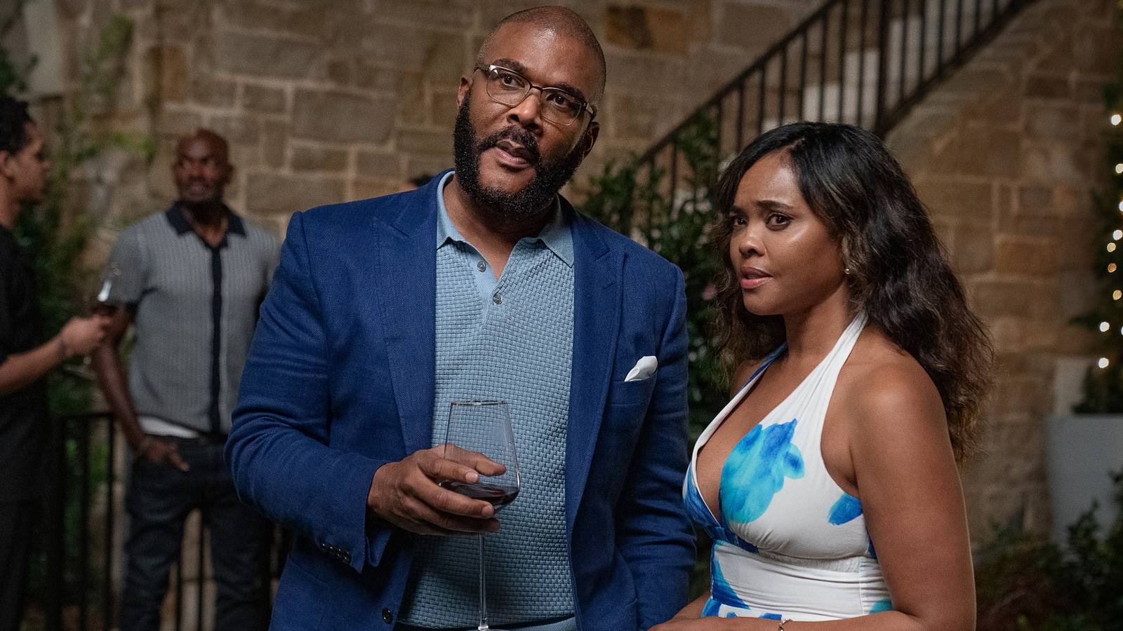 Tyler Perry's Terry and Sharon Leal's Diane looking concerned at something while holding wine gla...