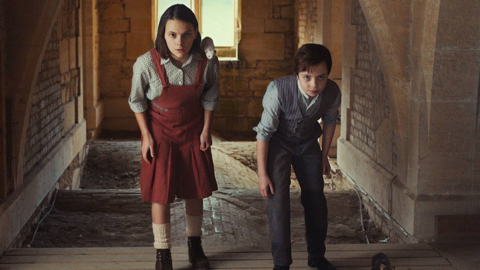 Lyra and a young boy looking nervous while exploring